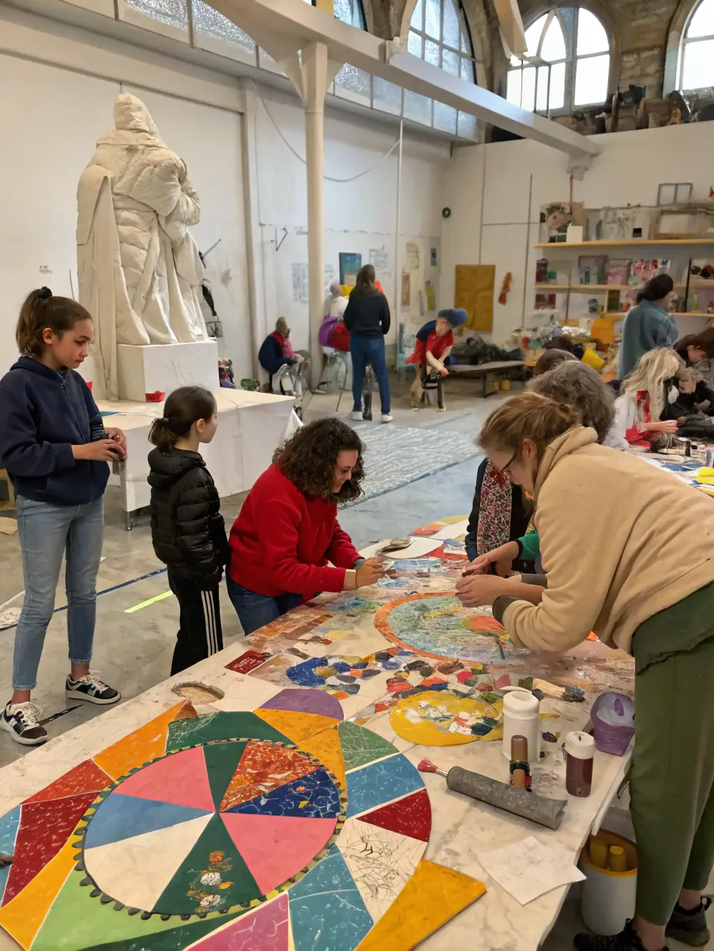 An inspiring image of a vibrant art workshop in progress, with participants of diverse ages and backgrounds actively engaged in creating art pieces under the guidance of an instructor.